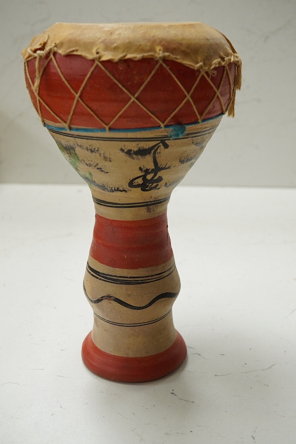 Five African drums; a Djembe, 60cm high, together with four small North African pottery double drums. Condition - fair to good.